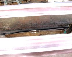 The crossbar itself, the brown item below the connecting rods.